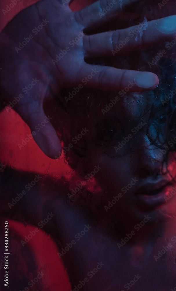 Portrait of man in shower with red and blue lights Portrait of man in shower with red and blue lights