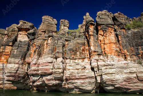 Western Australia – rocky eroded cliffs with trees and shrubs at a large river