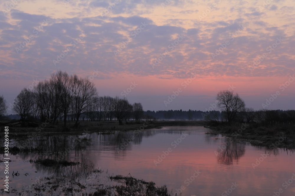 Colourful morning over the river flood