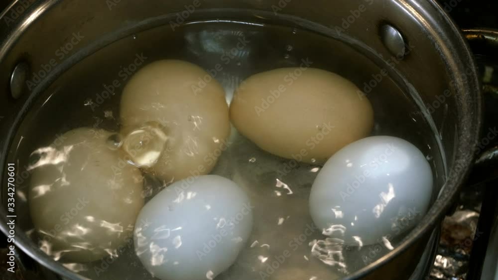 Cooking spring egg salad with green onions. Step by step. Chicken eggs are boiled in boiling water in saucepan. Cooking spring egg salad with green onions. Step by step. Chicken eggs are boiled in boiling water in saucepan.