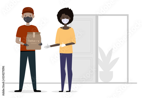 Courier in uniform, medical mask and gloves gives box to customer. Delivery services while quarantine