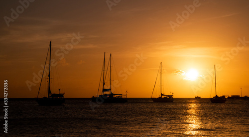 Few yachts in the sea at bright sunset.