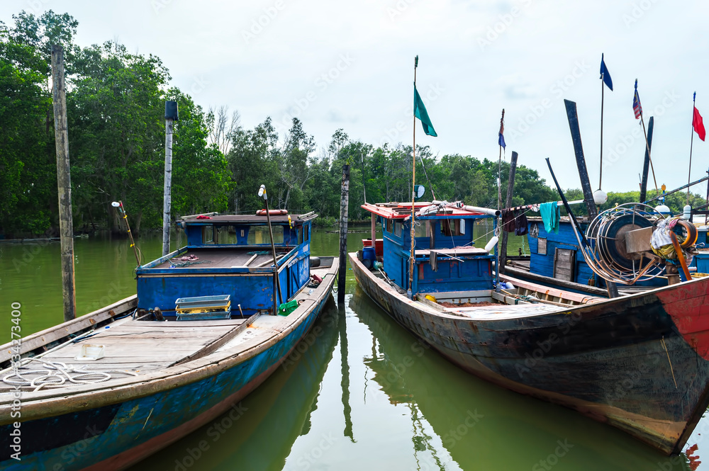 Fisherman boats park near jetty under the calm wheather