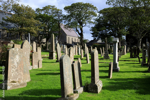 Kirkwall - Orkney (Scotland), UK - August 07, 2018: 12th century Romanesque Saint Magnus cathedral cemetery in Kirkwall, Orkney, Scotland, Highlands, United Kingdom