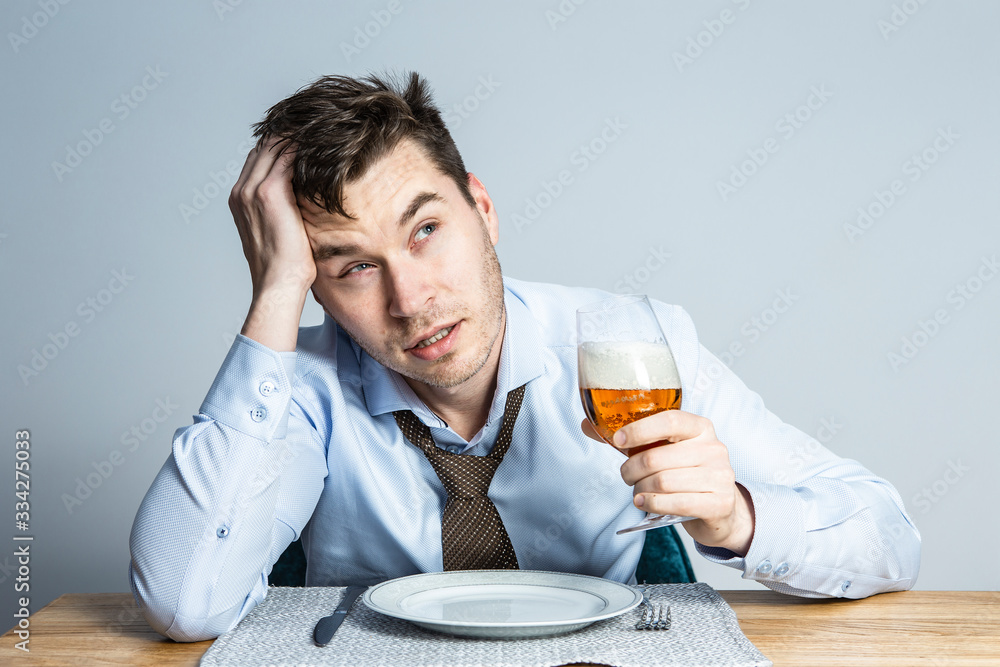 quarantine, self-isolation, coronavirus epidemic. A young man in a business shirt does not leave home due to a pandemic quarantine, self-isolation, coronavirus epidemic. A young man in a business shirt does not leave home due to a pandemic
