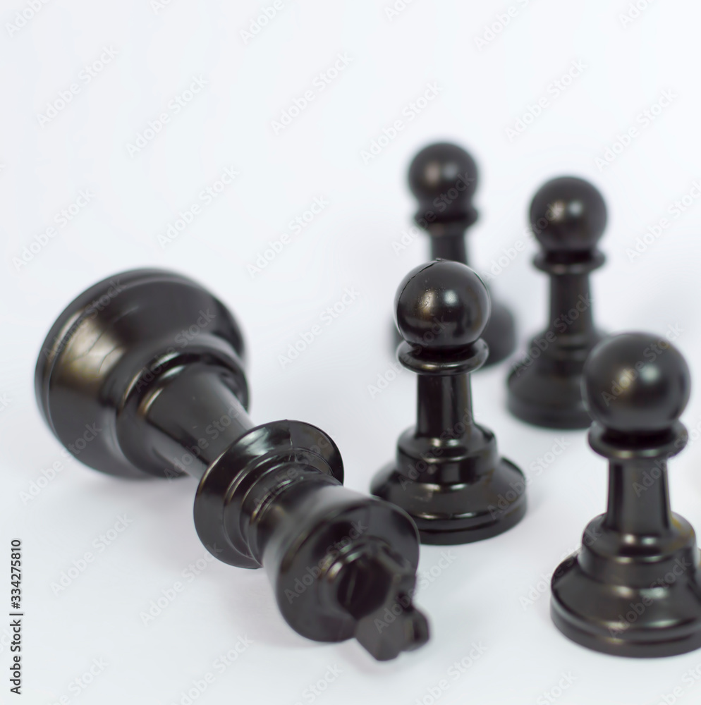 Black chess with white background. Focused at black pawn. Black chess with white background. Focused at black pawn.