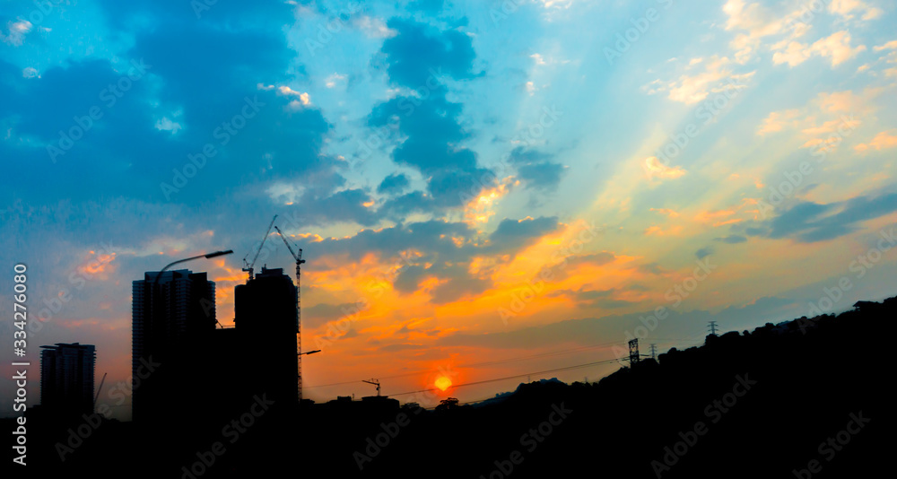 City silhouette with sunrise background