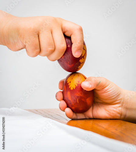 Two boys playing breeak the easter egg. There is only one winner.