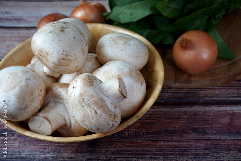 Mushrooms, spinach and onions on a wooden table Mushrooms, spinach and onions on a wooden table