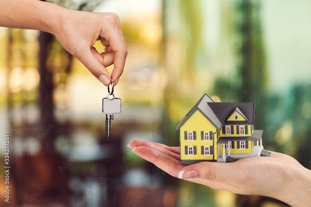 Hand giving of metal house keys and mini house Stock Photo Adobe Stock