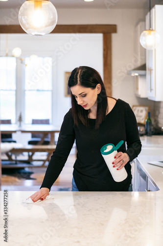 Woman Using Cloth To Disinfect And Clean Counter