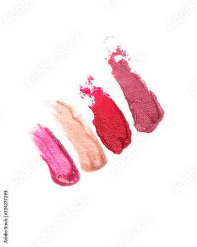 Tester of lipstick and lipgloss on a white background