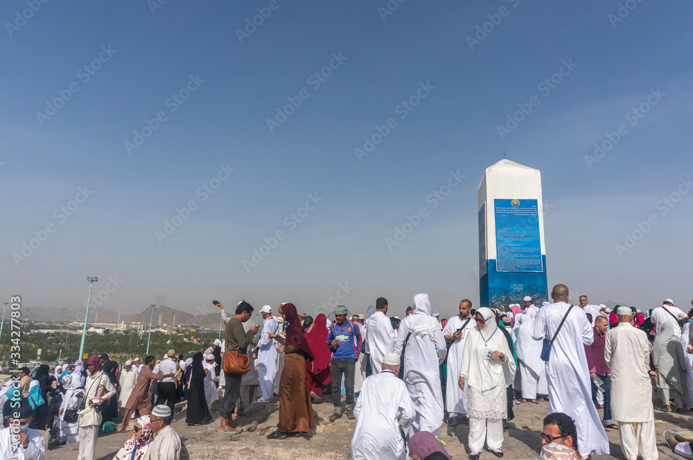 MECCA, SAUDI ARABIA - MAR 11: Muslims at Mount Arafat (or Jabal Rahmah) March 11, 2015 in Arafat, Saudi Arabia. This is the place where Adam and Eve met after being overthrown from heaven..