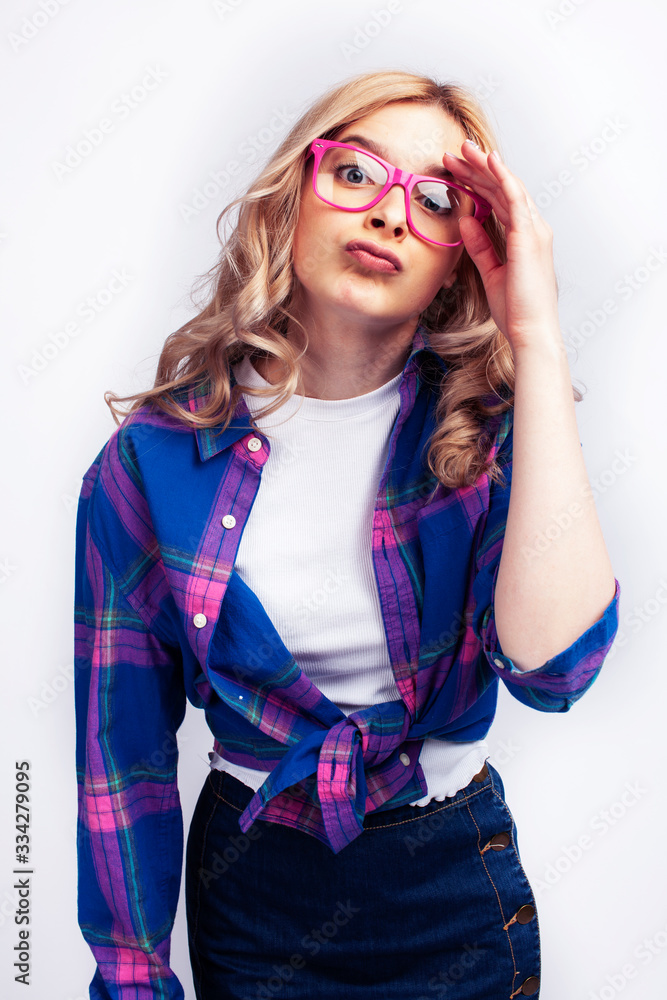 young pretty blond teenage hipster girl in glasses posing emotional happy smiling, gesturing isolated on white background, lifestyle poeple concept