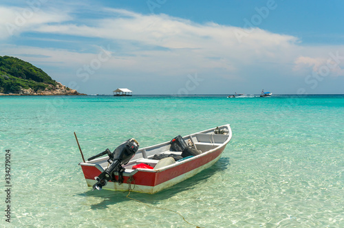 Boat with clear water and blue skies at Perhentian Island, Malaysia