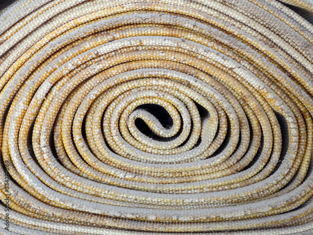 An old canvas fire hose in a roll. An old canvas fire hose in a roll.