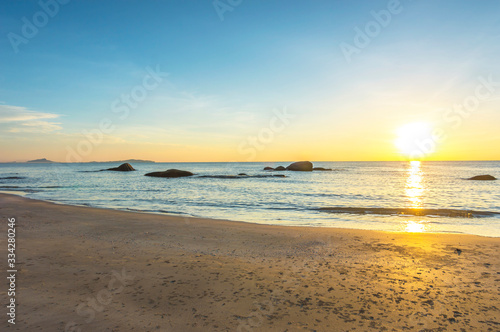 Beach wave with orange sunrise background