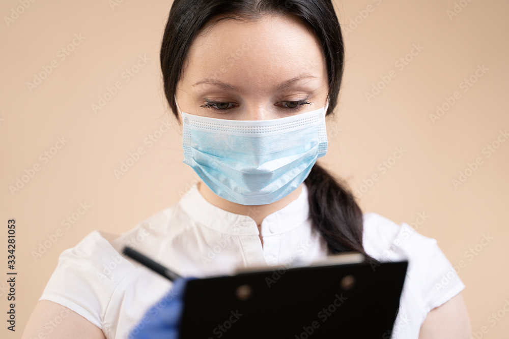 Girl doctor in rubber gloves and a medical mask with a tablet, the concept of preventing the spread of coronavirus. Girl doctor in rubber gloves and a medical mask with a tablet, the concept of preventing the spread of coronavirus.