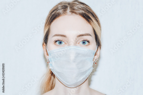 Woman with medical mask close up. Protection from covid-19