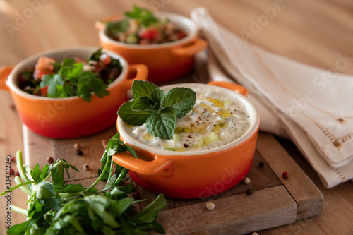 Close-up of a summer salad with yoghurt cucumber and mint