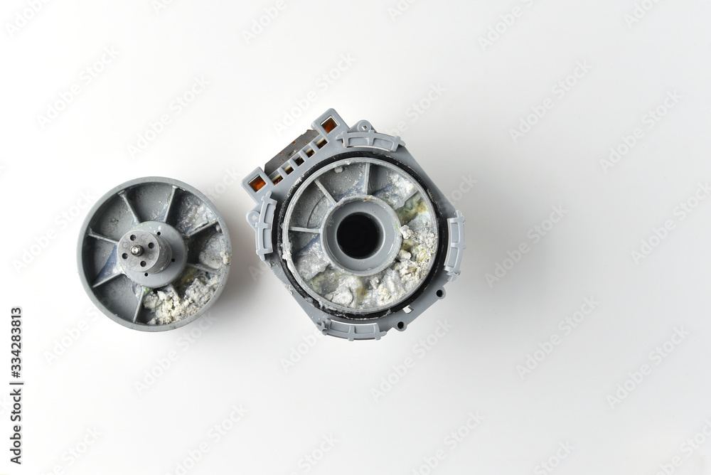 Parts of the water pump. Dishwasher. Limescale deposits. Hard water. Isolated on white background. Parts of the water pump. Dishwasher. Limescale deposits. Hard water. Isolated on white background.