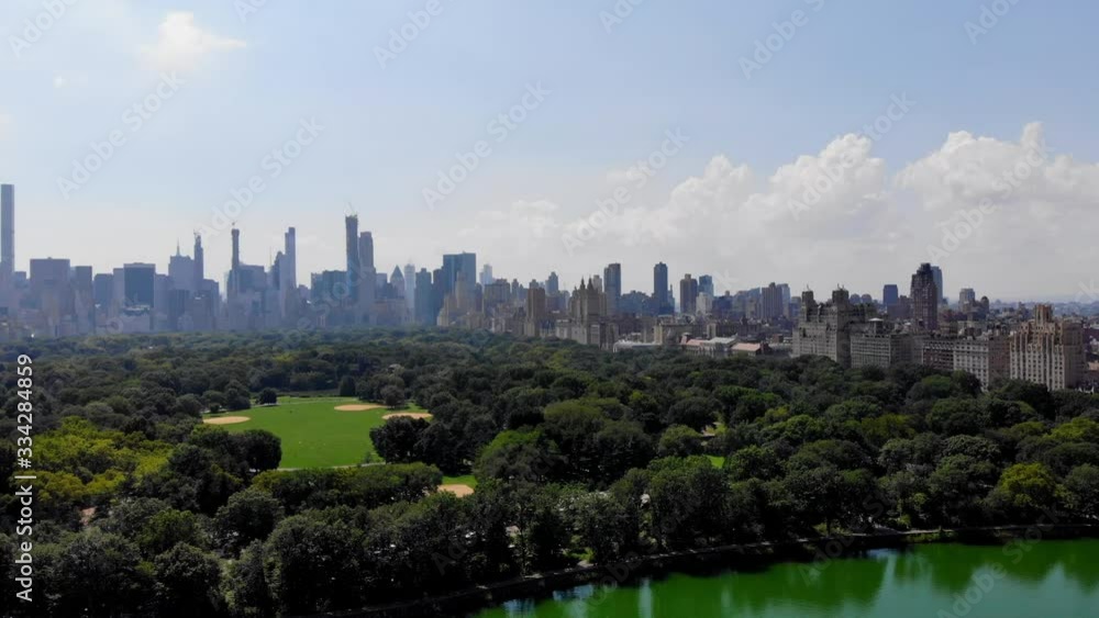 Concept of city lifestyle during day time in metropolitan area, aerial view during touristic helicopter tour on Central Park landscape with artificial lake in American megalopolis - New York Concept of city lifestyle during day time in metropolitan area, aerial view during touristic helicopter tour on Central Park landscape with artificial lake in American megalopolis - New York