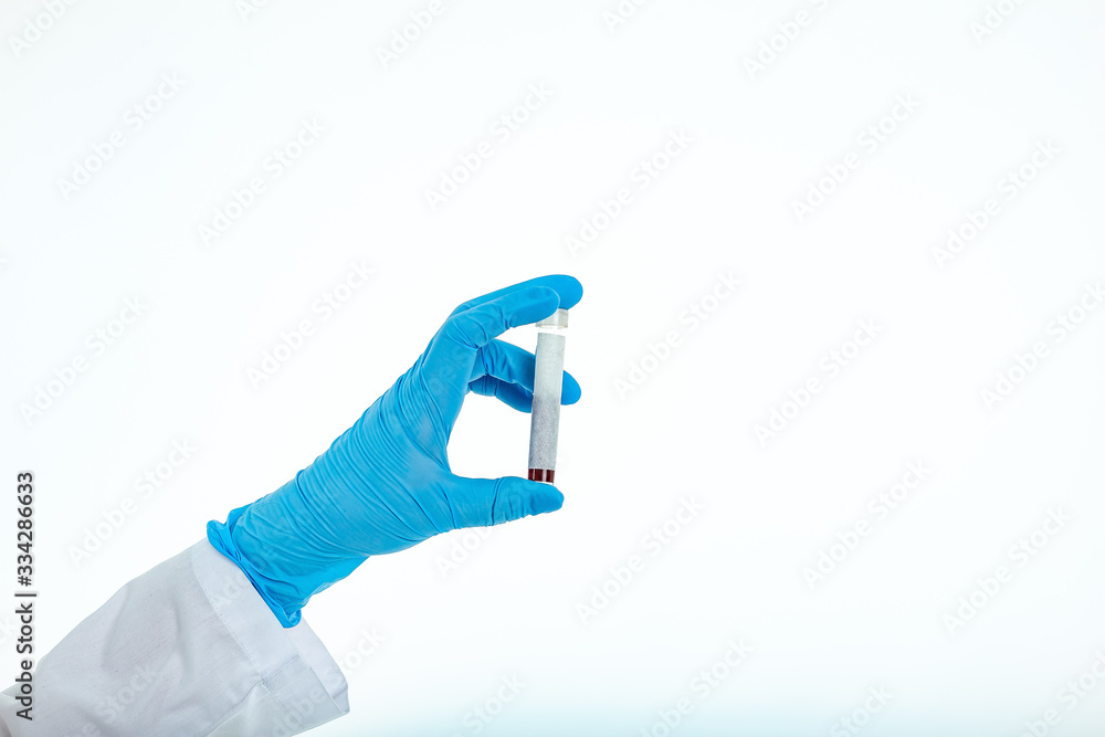 Doctor's hand in a medical glove holds a test tube with a place for inscription. Coronavirus drug search concept. Place for text. Isolated on a white background Doctor's hand in a medical glove holds a test tube with a place for inscription. Coronavirus drug search concept. Place for text. Isolated on a white background