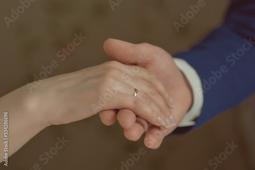 bride and groom holding their hands