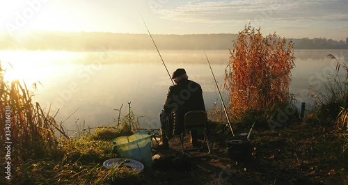 Amateur angler is fishing on autumn in the lake