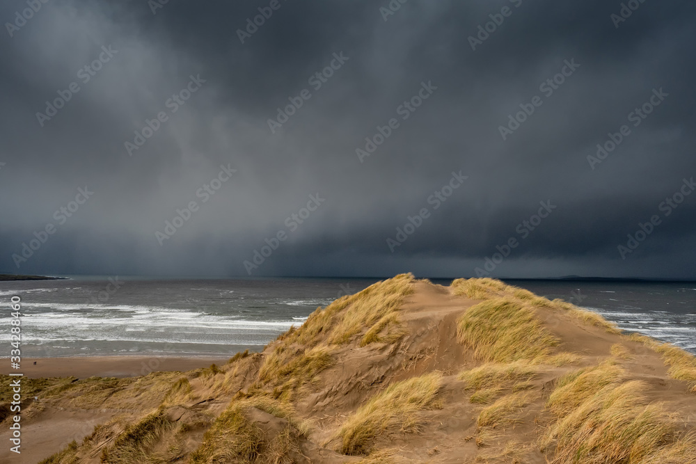 View from a dunne on a Strandhill beach and Atlantic ocean, Dark, dramatic storm cloud. County Sligo, Ireland.