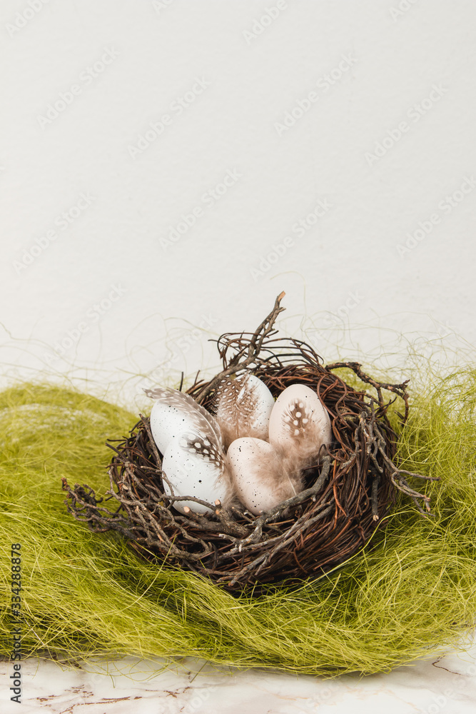 Easter eggs in a bird's nest on a marble background Easter eggs in a bird's nest on a marble background