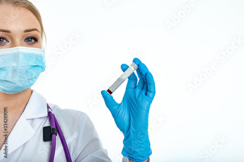 Doctor s hand in a medical glove holds a test tube with a place for inscription. Coronavirus drug search concept. Place for text. Isolated on a white background