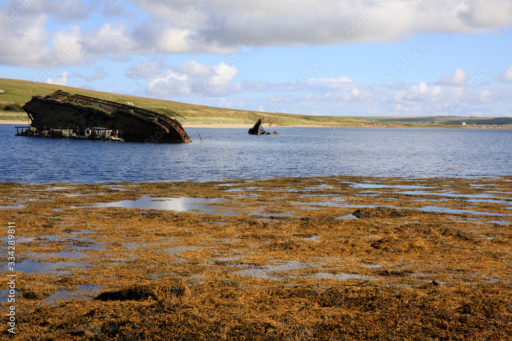 Scapa Flow - Orkney (Scotland), UK - August 08, 2018: World War II boat intentionally sunk to protect the natural harbour of Scapa Flow, Orkney, Scotland, Highlands, United Kingdom