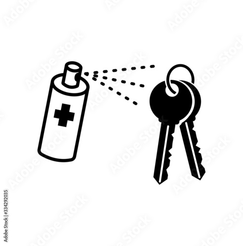 Hand wiping the house key with the alcohol sanitiser spray.
