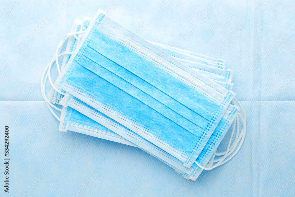 Medical mask, surgical protective masks on blue background. Disposable face mask cover the mouth and nose. Healthcare and medical concept. Coronovirus Covid-19 protective. Stop Sars-cov-2 virus Medical mask, surgical protective masks on blue background. Disposable face mask cover the mouth and nose. Healthcare and medical concept. Coronovirus Covid-19 protective. Stop Sars-cov-2 virus
