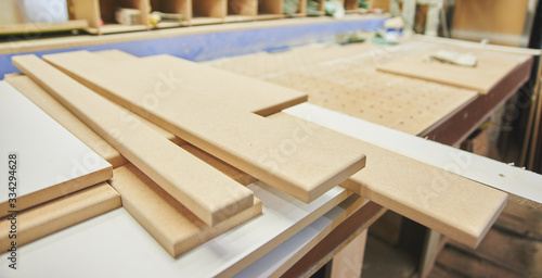 Wooden boards in a furniture workshop close-up, factory manufacturing