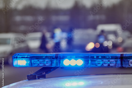 Blue lights of a police car at the scene of an accident photo