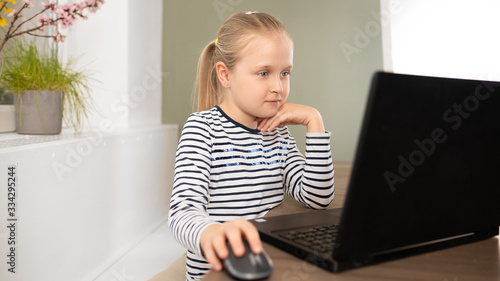 student is interested in watching computer during epidemic, home schooling distance learning using modern technologies