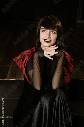 Cute magical woman in a vampire costume, a festive image for Halloween