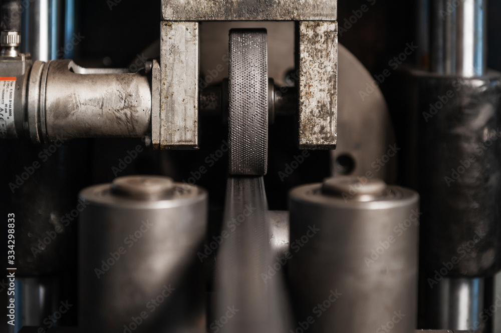 Production of metal products. Pipe forming. Close up Production of metal products. Pipe forming. Close up