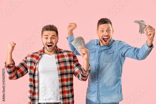 Happy men with money on col...