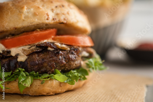 Gourmet Burger on a table next to a window