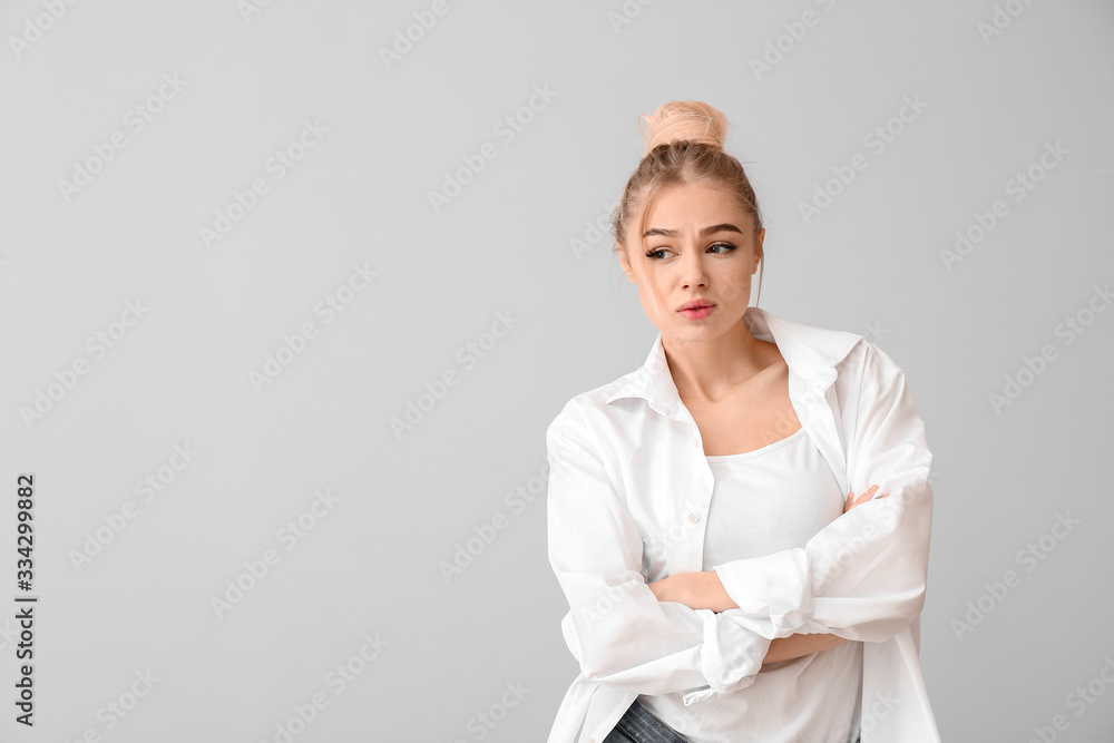 Portrait of beautiful young woman on grey background Portrait of beautiful young woman on grey background
