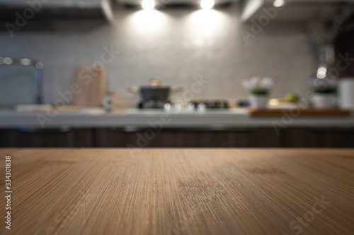Wooden table top on blur kitchen room background. For displaying the assembly product or visual arrangement of the configuration keys