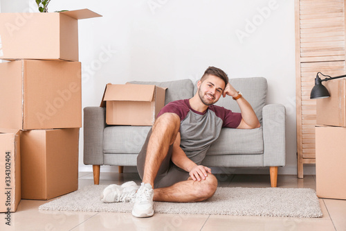 Young man with moving boxes...