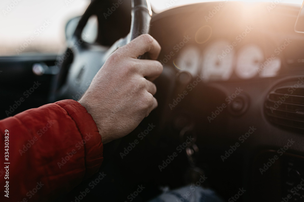summer car driver concept, hand on steering wheel.