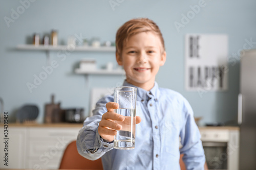 Cute little boy drinking wa...