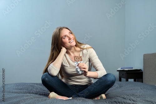 Portrait of beautiful positive young woman with chocolate with hazelnuts