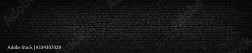 Texture of a black painted brick wall as a background or wallpaper © Günter Albers