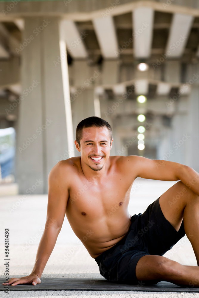 Mexican man practicing yoga in a urban background Mexican man practicing yoga in a urban background